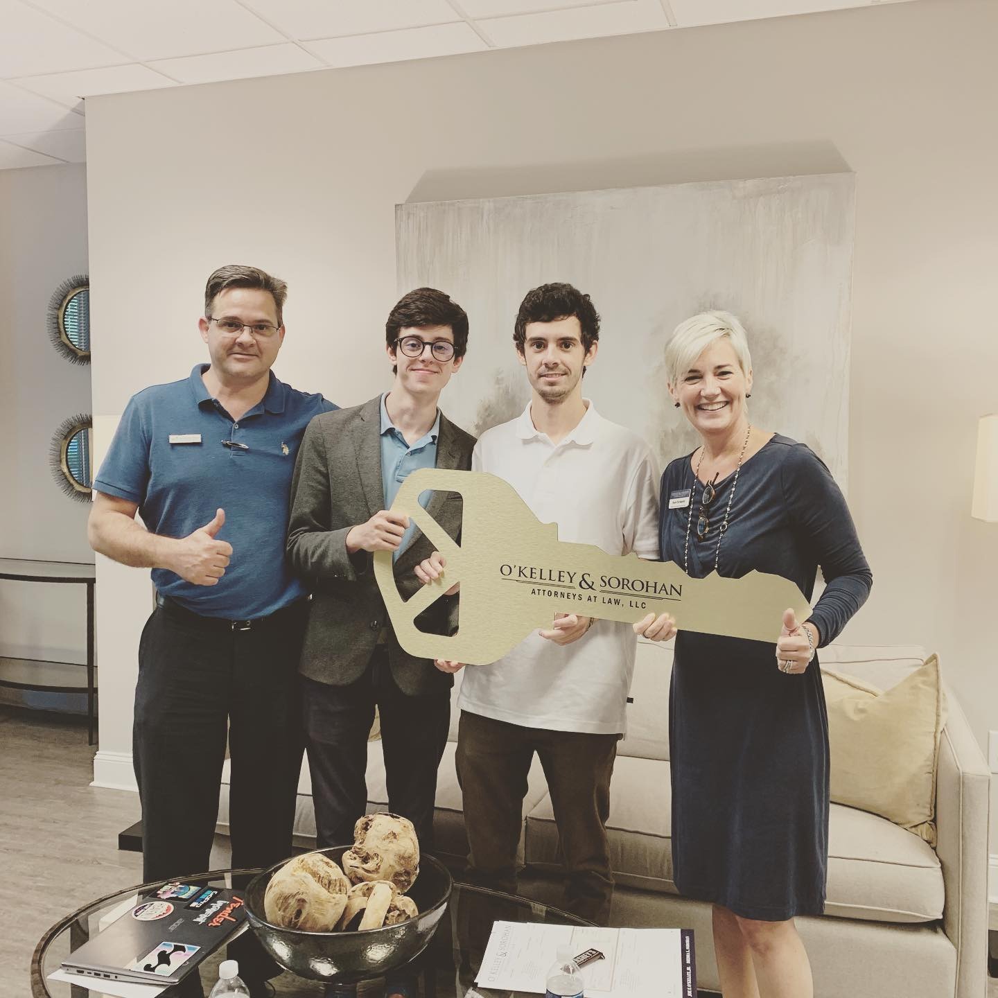 A 2019 closing. James Wheat at left, Collin Wheat second from left in a sport coat, holding a ceremonial key.
